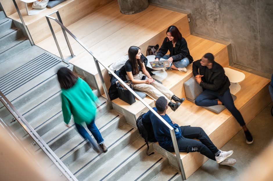 Students chatting by a staircase